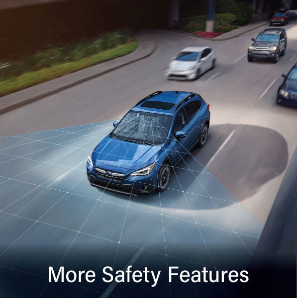 A Subaru Crosstrek in blue with the words “More Safety Features“. | SubaruDemo4 in Hermiston OR