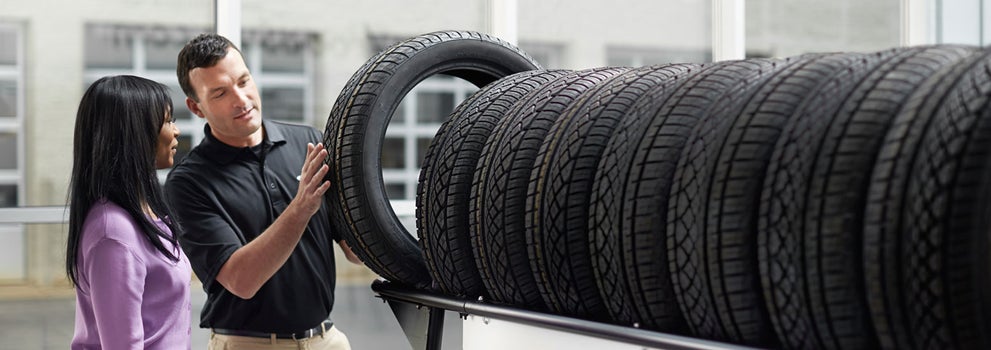 Subaru service representative showing customer a tire. | SubaruDemo4 in Hermiston OR